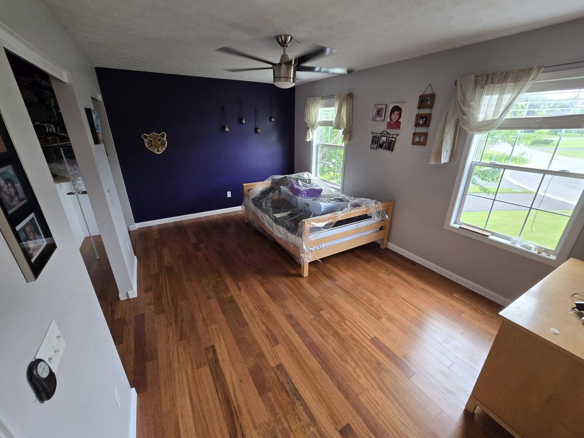 Brazilian Cherry hardwood in a bedroom with a navy accent wall